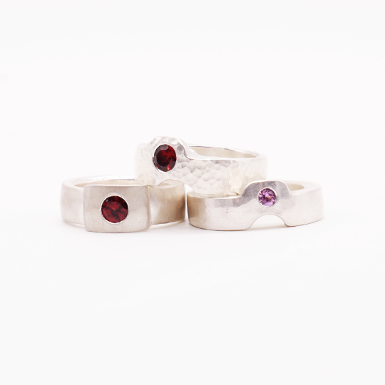 THREE RINGS WITH GARNETS AND A SAPPHIRE